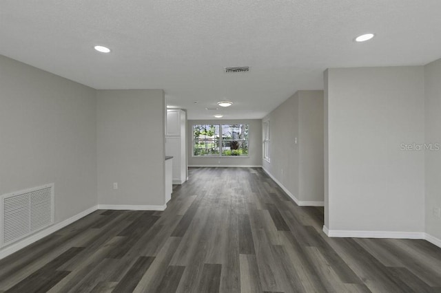 7625 Marechal Ave, Port Richey, FL 34668 - empty room with dark wood finished floors and recessed lighting