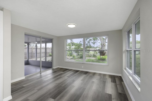 7625 Marechal Ave, Port Richey, FL 34668 - unfurnished sunroom featuring wood finished floors and baseboards