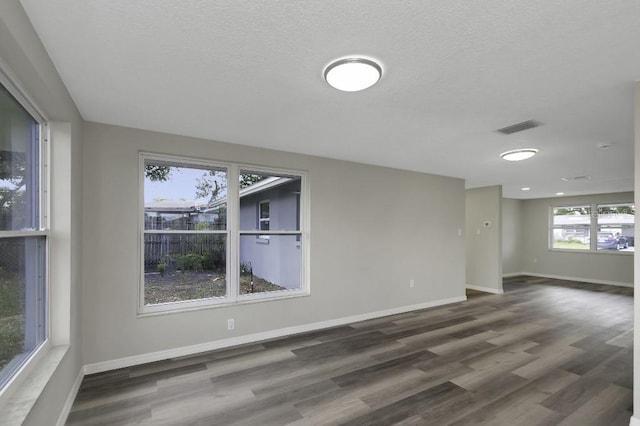 7625 Marechal Ave, Port Richey, FL 34668 - empty room with wood finished floors and a textured ceiling
