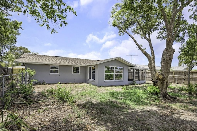 7625 Marechal Ave, Port Richey, FL 34668 - rear view of property with stucco siding and a sunroom