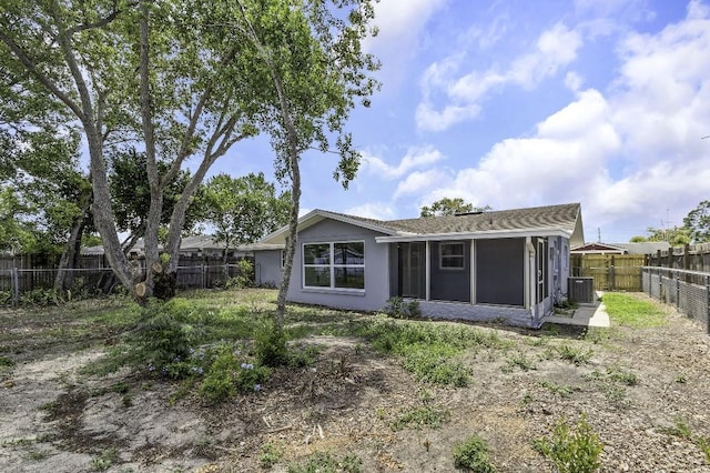 7625 Marechal Ave, Port Richey, FL 34668 - back of property featuring a sunroom, a fenced backyard, and stucco siding