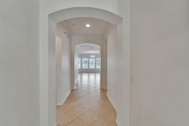 5205 Brighton Shore Dr, Apollo Beach, FL 33572 - hallway featuring light tile patterned floors, arched walkways, crown molding, and recessed lighting