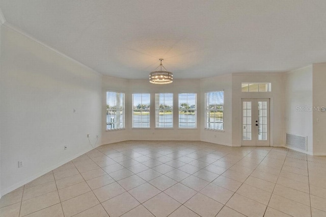 5205 Brighton Shore Dr, Apollo Beach, FL 33572 - empty room with healthy amount of natural light, a chandelier, and light tile patterned floors