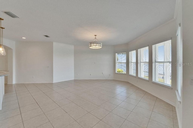 5205 Brighton Shore Dr, Apollo Beach, FL 33572 - spare room with light tile patterned floors, a chandelier, arched walkways, recessed lighting, and crown molding