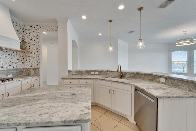 5205 Brighton Shore Dr, Apollo Beach, FL 33572 - kitchen featuring appliances with stainless steel finishes, light stone counters, a kitchen island, backsplash, and white cabinets