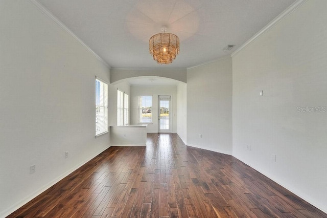 5205 Brighton Shore Dr, Apollo Beach, FL 33572 - empty room featuring arched walkways, crown molding, dark wood-style flooring, and a chandelier