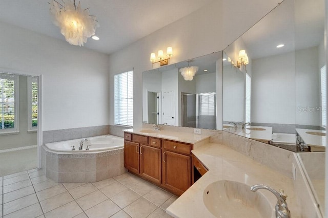 5205 Brighton Shore Dr, Apollo Beach, FL 33572 - full bath with two vanities, a bath, tile patterned flooring, a stall shower, and a chandelier