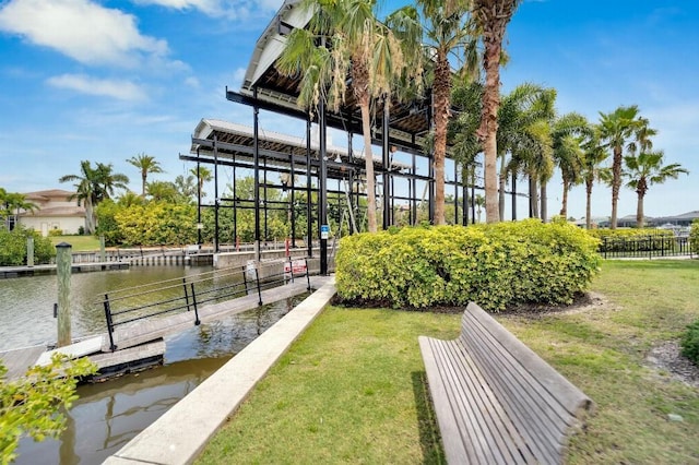 5205 Brighton Shore Dr, Apollo Beach, FL 33572 - surrounding community with a boat dock, a water view, and a lawn