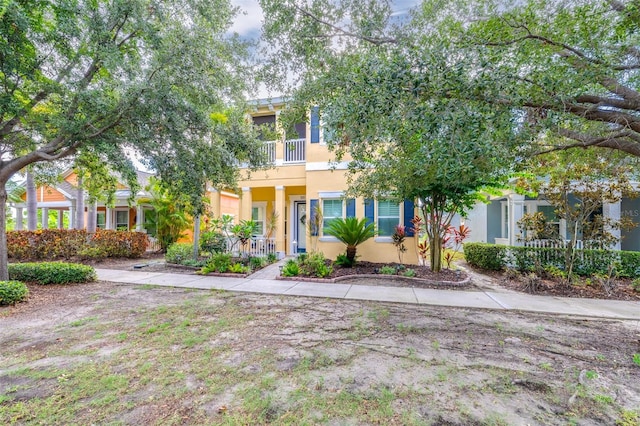 511 Winterside Dr, Apollo Beach, FL 33572 - view of property hidden behind natural elements with stucco siding and a balcony