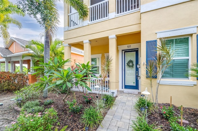 511 Winterside Dr, Apollo Beach, FL 33572 - property entrance featuring a porch, stucco siding, and a balcony