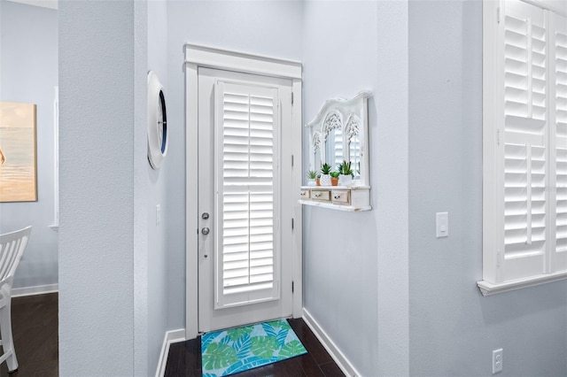 511 Winterside Dr, Apollo Beach, FL 33572 - doorway with dark wood-type flooring and baseboards
