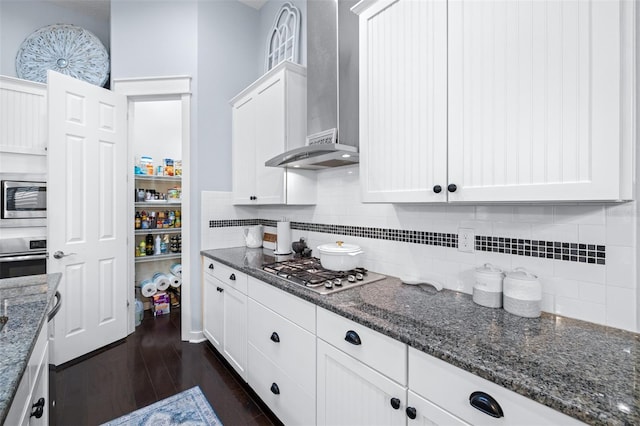 511 Winterside Dr, Apollo Beach, FL 33572 - kitchen featuring stainless steel appliances, wall chimney range hood, white cabinets, and dark wood-style flooring