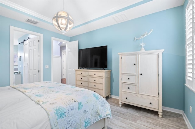 511 Winterside Dr, Apollo Beach, FL 33572 - bedroom featuring light wood-type flooring and a barn door