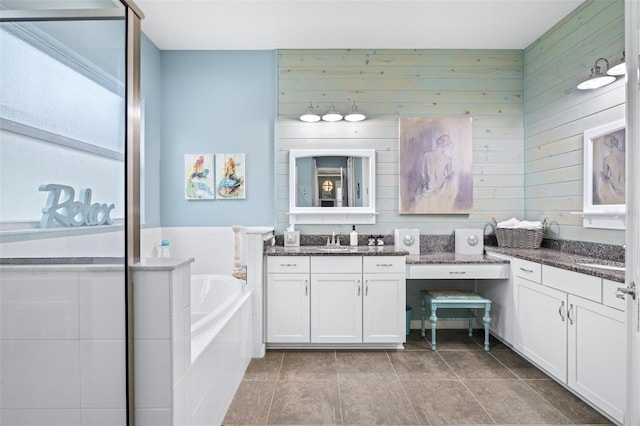 511 Winterside Dr, Apollo Beach, FL 33572 - bathroom with a bath, vanity, wooden walls, and tile patterned floors