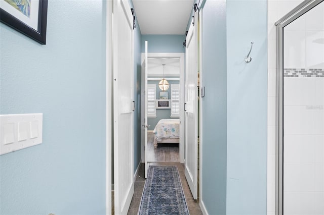 511 Winterside Dr, Apollo Beach, FL 33572 - corridor featuring a barn door and baseboards