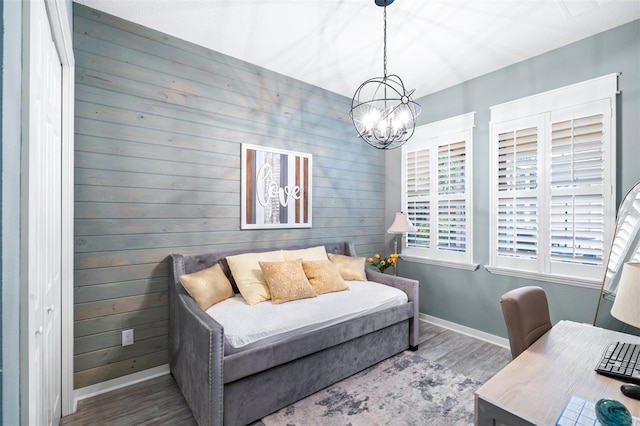 511 Winterside Dr, Apollo Beach, FL 33572 - bedroom featuring wood finished floors, a chandelier, and wood walls