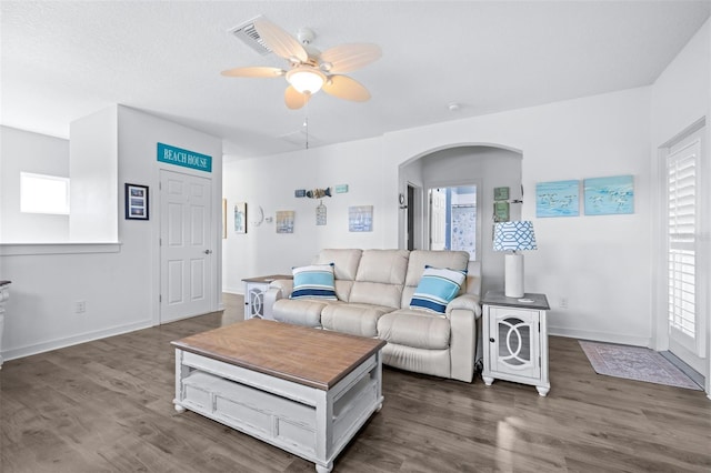 511 Winterside Dr, Apollo Beach, FL 33572 - living room featuring plenty of natural light, ceiling fan, arched walkways, and dark wood finished floors