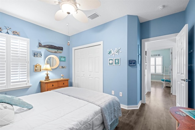 511 Winterside Dr, Apollo Beach, FL 33572 - bedroom with dark wood-style flooring, a closet, and a ceiling fan