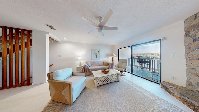 12132 Capri Cir S, Treasure Island, FL 33706 - living area featuring a textured ceiling, a ceiling fan, and carpet