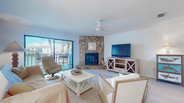 12132 Capri Cir S, Treasure Island, FL 33706 - living area with a ceiling fan and a fireplace