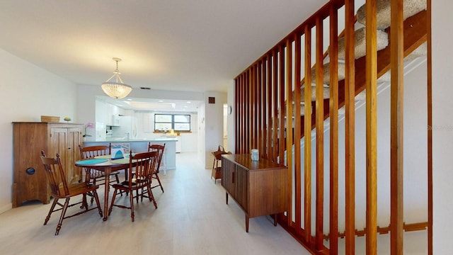12132 Capri Cir S, Treasure Island, FL 33706 - dining area featuring light wood-type flooring and baseboards