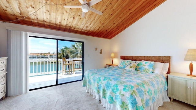 12132 Capri Cir S, Treasure Island, FL 33706 - bedroom featuring light colored carpet, access to outside, wood ceiling, a water view, and vaulted ceiling