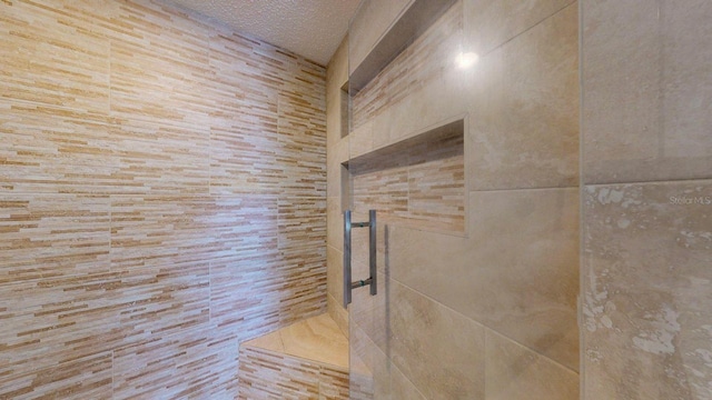 12132 Capri Cir S, Treasure Island, FL 33706 - bathroom view of a textured ceiling and a tile shower