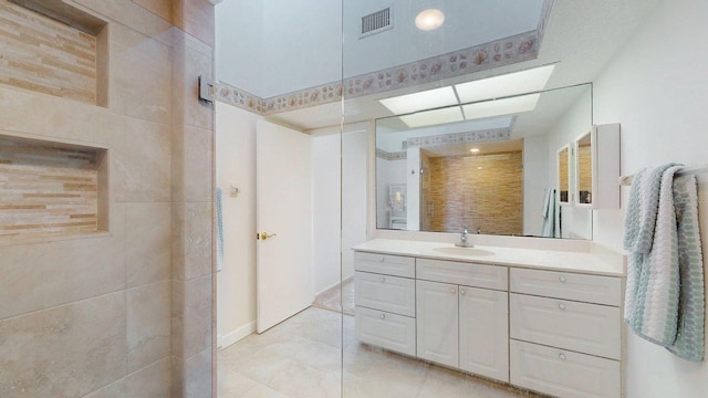 12132 Capri Cir S, Treasure Island, FL 33706 - full bathroom with vanity, tile patterned flooring, and tiled shower