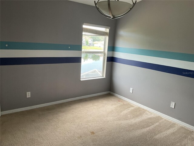 15733 Stable Run Dr, Spring Hill, FL 34610 - spare room featuring carpet and baseboards