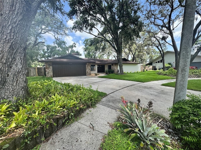 2102 Doefield Ct, Valrico, FL 33596 - view of front of house with concrete driveway, a garage, and stone siding