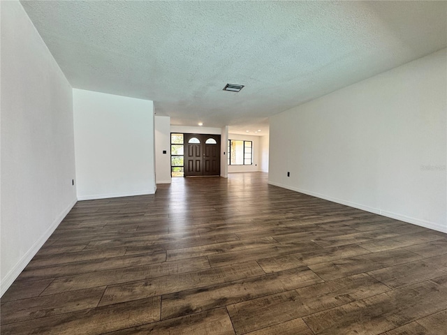 2102 Doefield Ct, Valrico, FL 33596 - unfurnished living room featuring dark wood finished floors and a textured ceiling