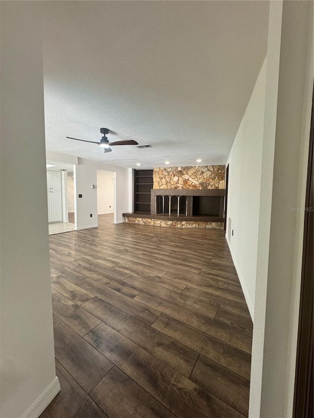 2102 Doefield Ct, Valrico, FL 33596 - unfurnished living room with dark wood finished floors, a fireplace, and ceiling fan