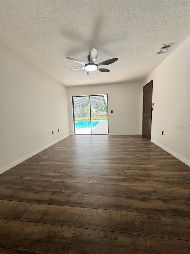 2102 Doefield Ct, Valrico, FL 33596 - empty room with dark wood-style flooring, a ceiling fan, and a textured ceiling
