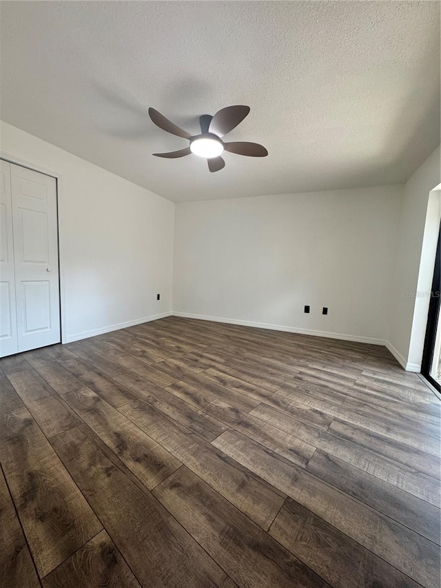 2102 Doefield Ct, Valrico, FL 33596 - unfurnished bedroom with dark wood-style flooring, a textured ceiling, and ceiling fan