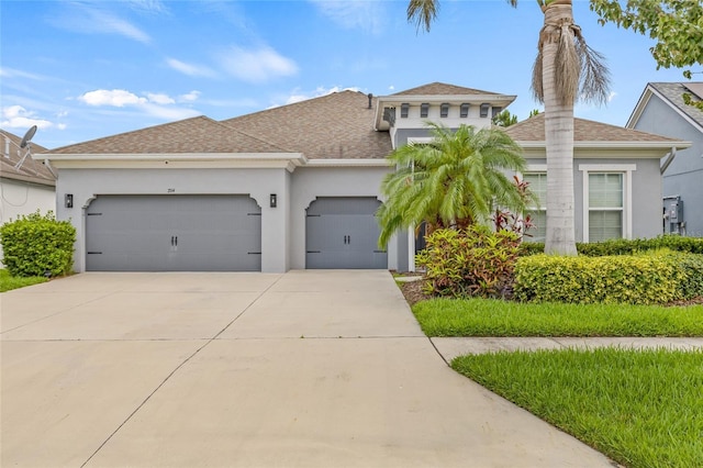 7114 Bowspirit Pl, Apollo Beach, FL 33572 - view of front of home with an attached garage, stucco siding, and concrete driveway