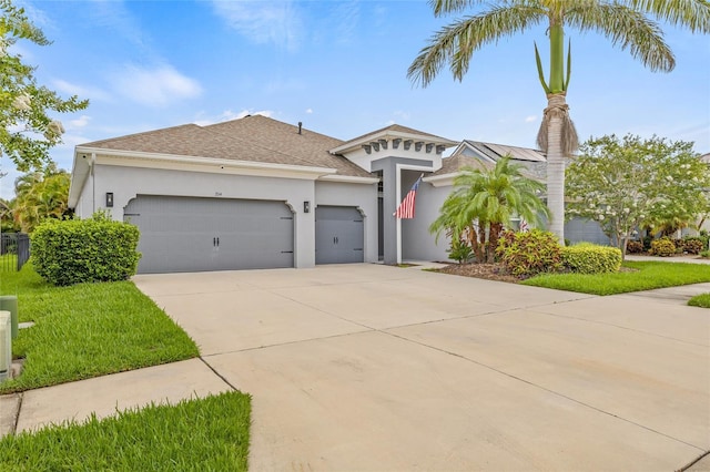 7114 Bowspirit Pl, Apollo Beach, FL 33572 - view of front of house featuring an attached garage, driveway, stucco siding, a front yard, and a shingled roof