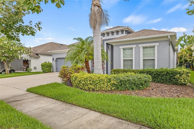 7114 Bowspirit Pl, Apollo Beach, FL 33572 - view of front of house with stucco siding, a garage, driveway, and a shingled roof