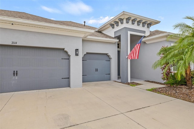 7114 Bowspirit Pl, Apollo Beach, FL 33572 - view of front of house with stucco siding, driveway, roof with shingles, and an attached garage