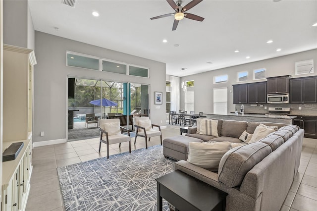 7114 Bowspirit Pl, Apollo Beach, FL 33572 - living room featuring recessed lighting, light tile patterned floors, plenty of natural light, a ceiling fan, and a high ceiling