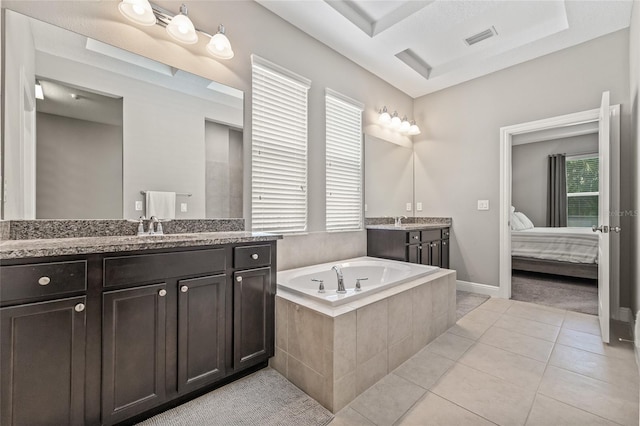 7114 Bowspirit Pl, Apollo Beach, FL 33572 - bathroom with healthy amount of natural light, two vanities, a garden tub, and tile patterned flooring