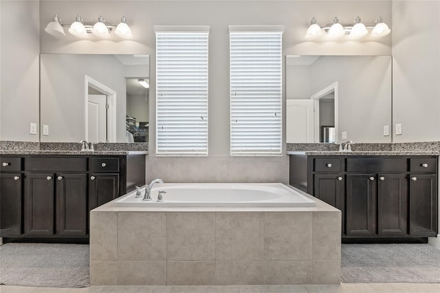 7114 Bowspirit Pl, Apollo Beach, FL 33572 - full bath featuring two vanities, a garden tub, and tile patterned flooring