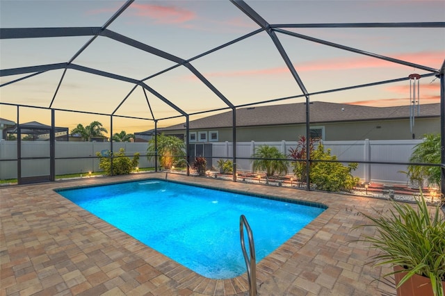 13301 Waterleaf Garden Cir, Riverview, FL 33579 - pool at dusk with a patio, a fenced backyard, and a lanai