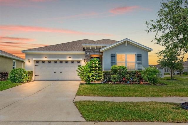 13301 Waterleaf Garden Cir, Riverview, FL 33579 - view of front of property with a garage, stone siding, concrete driveway, a front yard, and a shingled roof