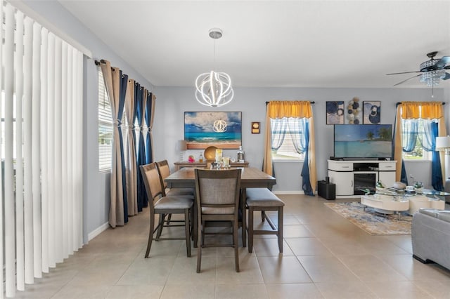 13301 Waterleaf Garden Cir, Riverview, FL 33579 - dining area with a chandelier, a ceiling fan, and light tile patterned flooring
