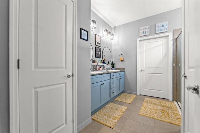 13301 Waterleaf Garden Cir, Riverview, FL 33579 - bathroom featuring double vanity, a stall shower, and tile patterned flooring