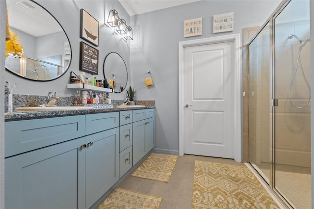 13301 Waterleaf Garden Cir, Riverview, FL 33579 - bathroom featuring double vanity, a shower stall, and tile patterned floors