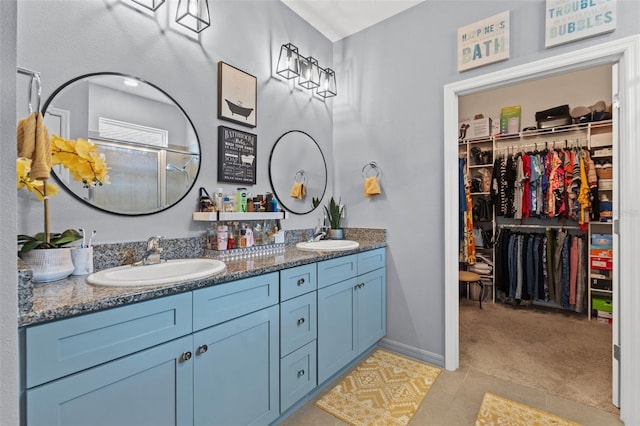 13301 Waterleaf Garden Cir, Riverview, FL 33579 - full bath with double vanity, a walk in closet, and tile patterned flooring