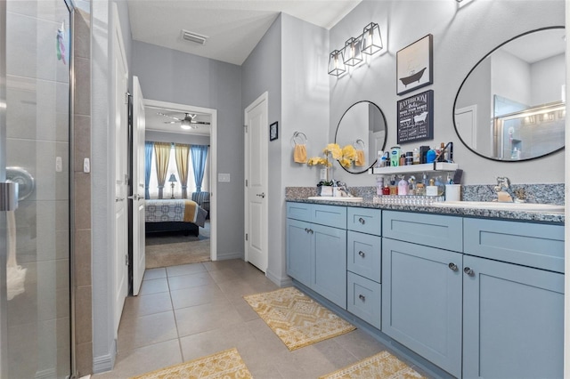 13301 Waterleaf Garden Cir, Riverview, FL 33579 - ensuite bathroom with double vanity, a stall shower, tile patterned floors, and a ceiling fan