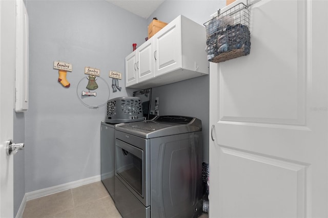 13301 Waterleaf Garden Cir, Riverview, FL 33579 - laundry area featuring washing machine and dryer, cabinet space, and light tile patterned flooring