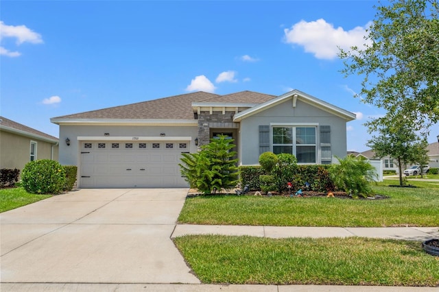 13301 Waterleaf Garden Cir, Riverview, FL 33579 - single story home with an attached garage, driveway, a front lawn, stone siding, and roof with shingles